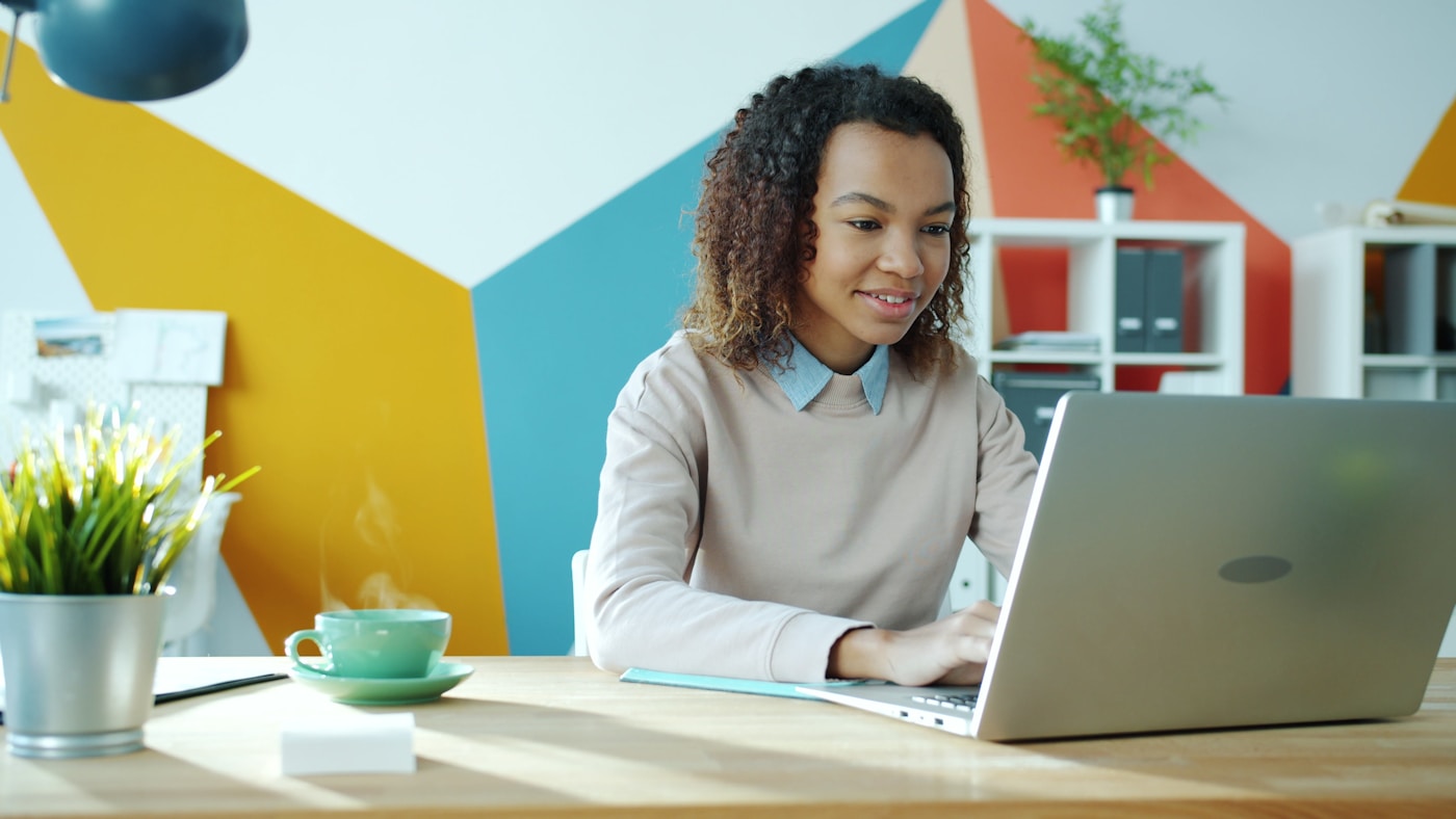 A happy student studying online